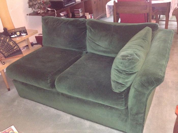 Green velour loveseat, which can be put together with the sofa in the previous frame as a sectional.