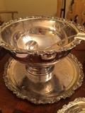 One of two silver punch bowls and underplate