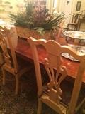 Eight light colored wood dining chairs