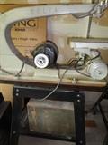 Delta scroll saw on stand.  vintage tool box below