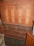 3 of several antique trunks and foot lockers