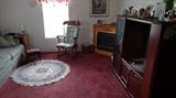 TV stand, fireplace, area rug, rocker, end tables