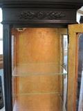 Obelisk shaped lighted curio cabinet.