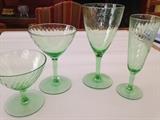 Set of Depression Era green crystal glasses Spiral pattern. Maker unknown. 11 champagne, 12 water goblets, 6 cocktail glasses, 4 sherbet/dessert.