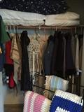 Coats, jackets, crochet blankets, metal quilt rack