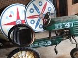vintage chain drive children tractor and some hex signs in back