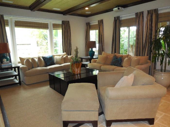 2 Neutral 7' sofas, most comfortable chair and ottoman ever, huge black coffee table, 2 side tables, teal table lamps, potted plants
