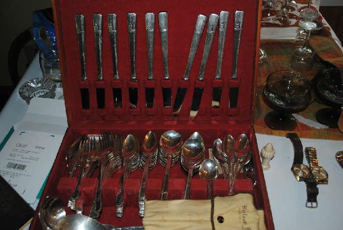 One of two silver plate sets of flatware
