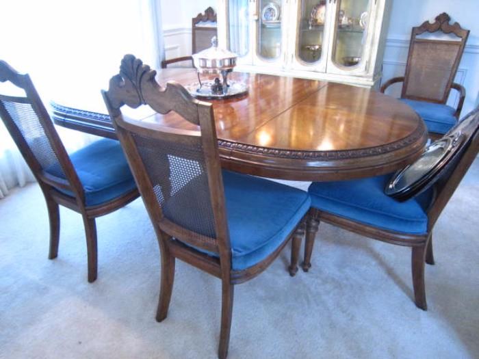 Dining Table with 2 leaves, 6 chairs (2 arm chairs) and pads.  Goes from 42" in diameter round to 80" with both leaves.