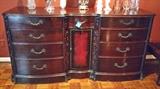 Antique mahogany sideboard with carved trim.