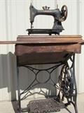 Antique sewing machine /table. Base of the table is cast iron with solid oak top. Sewing machine is an Arlington with a Cash Buyer's Union (Chicago) seal on it.