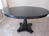 Adorable round dining table with pedestal base.