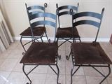 Four wrought iron chairs with new padded seats. Goes great with little black dining table.