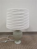 Ceramic lamp with pleated shade.