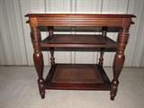 Solid wood end table with stained cain shelves. Matches credenza and coffee table in this same auction.