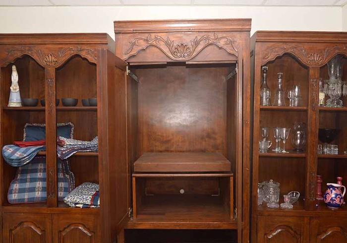 Doors slide inside the cabinet, and the TV stand pulls out and swivels.