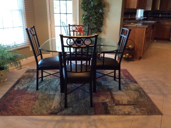Tempo Wrought Iron and glass dining table and 4 chairs on another fun rug