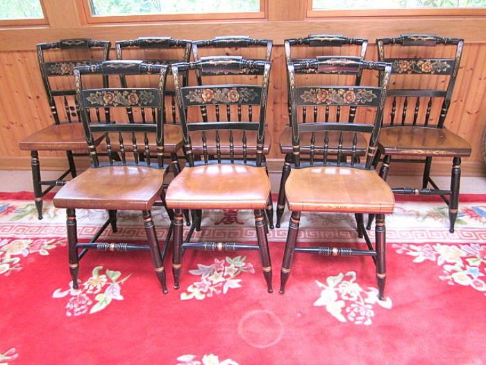 Set of eight signed Hitchcock chairs and partial view of Oriental rug.