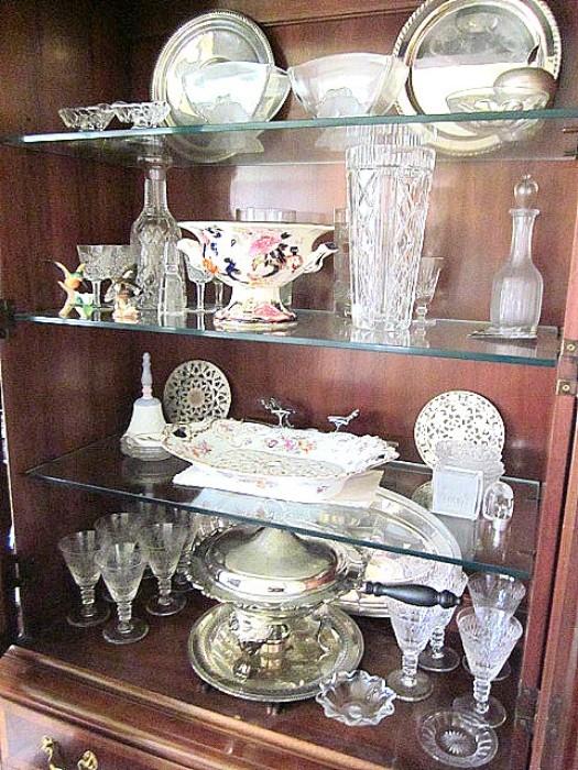 Items one side of china cabinet including Waterford vase and wine set, sterling tray, Gaudy Welsh masons tureen, stemware & etc.