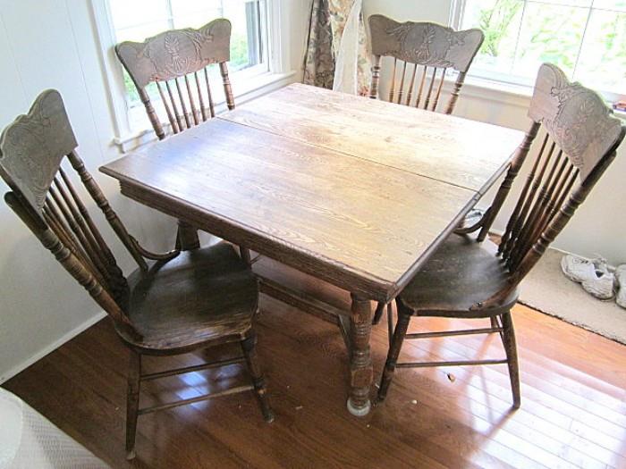antique square oak table & four pressed back chairs.