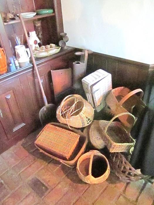 Selection baskets, antique shovel, kraut cutter and planter.