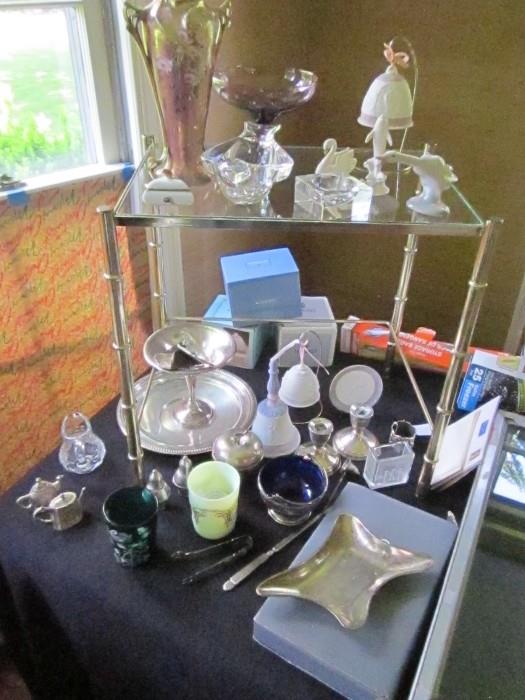 some of the sterling items including a Tiffany sterling apple covered dish. also shown Lladro goose, and bells.