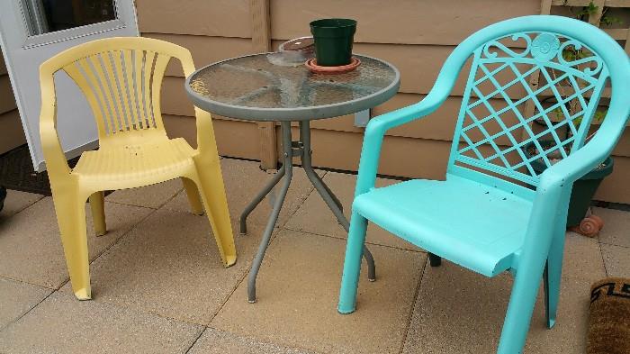 painted plastic chairs....glass top table
