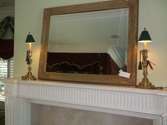 Large beveled mirror and brass candlestick lamps