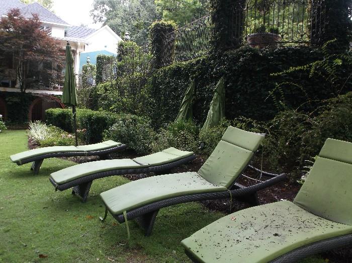 Four chaise lounges and three umbrellas