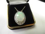 Opal and Diamond pendant mounted in 14k gold with recent appraisal starts at $1,200