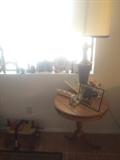 The other brass lamp, camel saddle (on ground), vintage side table, etc