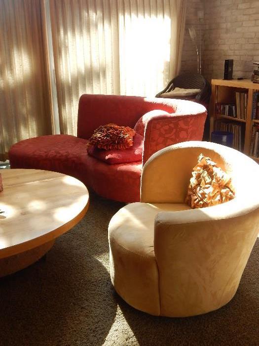 Mid century modern living room with two swivel suede chairs and two curved custom chaise sofas.