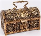 Lot #83, Antique Arch Top Art Nouveau Brass Trinket Box
Antique Arch Top Chest Art Nouveau Heavy Brass Trinket Jewelry Keepsake or Letter Box. Beautiful hi relief Art Nouveau designs of elegant flowing flowers, filigree motifs with Gothic or Victorian accents. Made of heavy brass. Box has a satin-lined Interior. Lock Is may not be complete, no key. Some Wear To Satin Lining. Impressed Lion stamp on the bottom. Believe to be from the late 19th or early 20th century. Measures 7.5" by 4" wide by 4.5" deep. Tag Words: Jewelry, Keepsake, IntDes, Artwork, Vanity, Ladies, Desktop