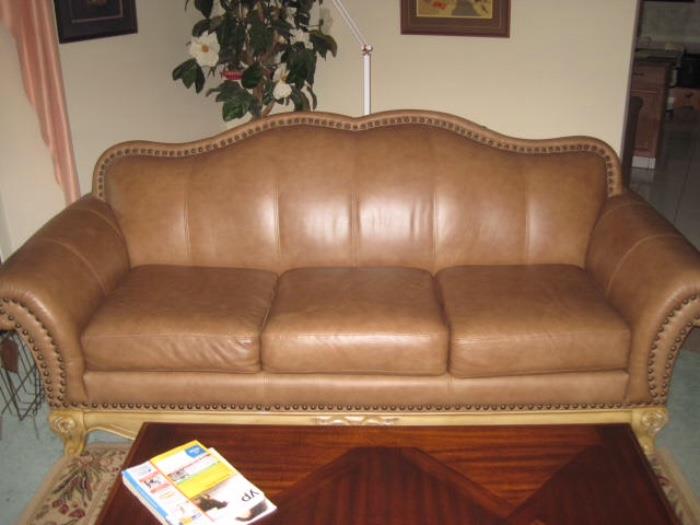 Leather sofa on wood frame trimmed with nail heads.  Excellent condition.