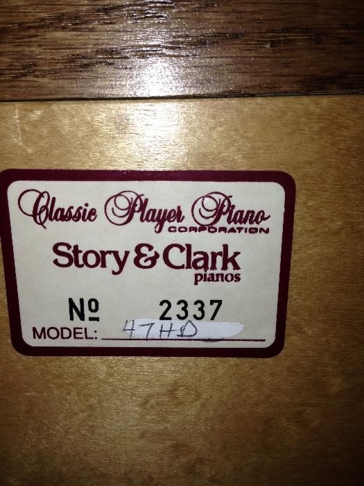 Story Clark Electric player piano with bench and includes over 30 rolls! the front glass panels light up even when not in use!