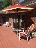 patio table, umbrella and 4 padded chairs