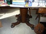 Antique round oak table with claw feet and lion heads