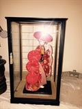 We have a pair of Oriental Dolls in glass cases
