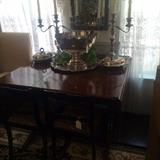 Duncan Phyfe drop leaf dining table; matching silver plate punch bowl and candelabras; beveled mirror 
