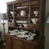 Primitive hutch with a variety of white dishes