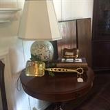 Antique drum table, Asian lamp, and brass fireplace tool
