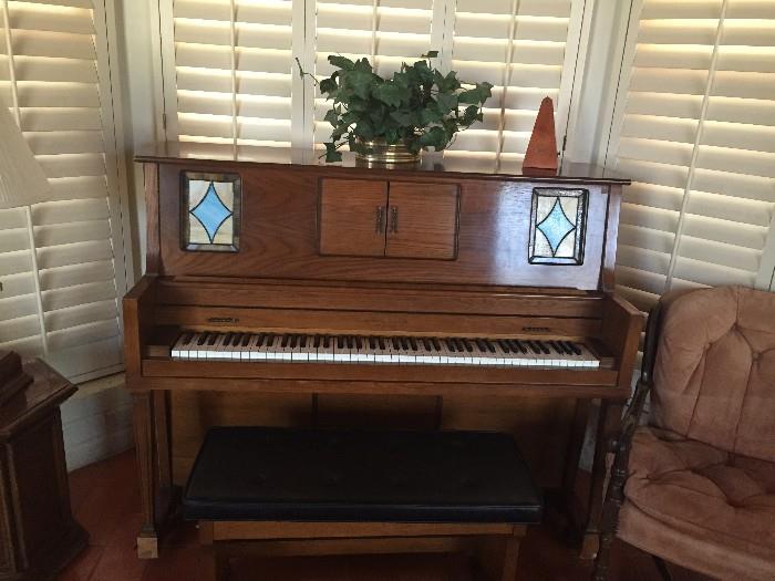 Universal upright player piano with many musical scrolls.