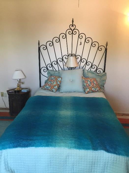 Unusual wrought iron headboard and bed.