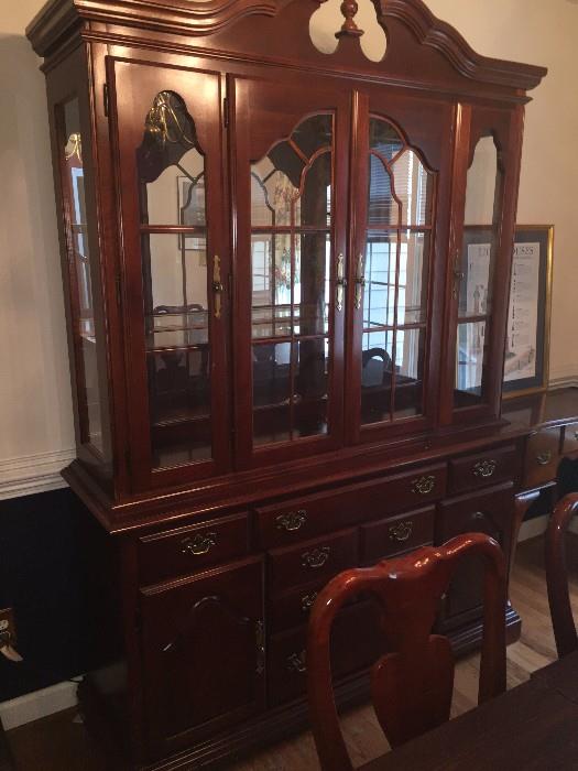 This is a Queen Anne dining room set by American Drew. It includes 8 chairs, a table for 10 that has 2 leaves, a custom-made table pad, the hutch and china closet, and a 5 foot sideboard with a custom glass top. The set was purchased in 1989 and has had only one owner. It has been in a house with no children and has only been moved once. It is in very good shape; the owner would like to sell the whole set as a unit. The asking price is $2600, but it is negotiable. Also, the sideboard does not have to be sold with the dining set.