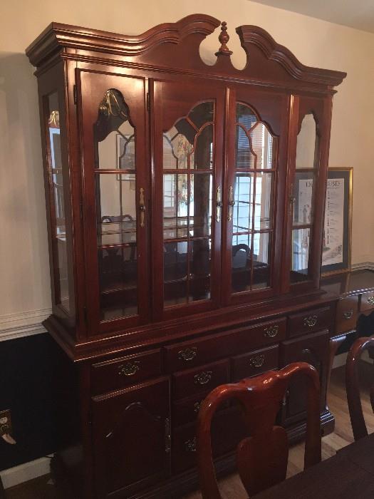 This is a Queen Anne dining room set by American Drew. It includes 8 chairs, a table for 10 that has 2 leaves, a custom-made table pad, the hutch and china closet, and a 5 foot sideboard with a custom glass top. The set was purchased in 1989 and has had only one owner. It has been in a house with no children and has only been moved once. It is in very good shape; the owner would like to sell the whole set as a unit. The asking price is $2600, but it is negotiable. Also, the sideboard does not have to be sold with the dining set.