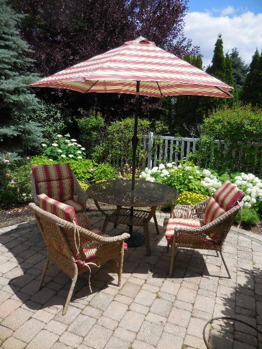 Wicker Patio Set. 4 Arm Chairs with Cushions, Glass Table with Wicker Frame. Umbrella with Stand