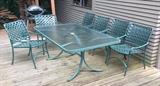Patio set by Tropitone - rectangular glass top table (40" x 66") + 6 chairs. In the background: Weber grill in background.