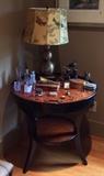 Two tier round side table by Woodbridge Furniture Co., lamp with silk bird shade (also from Del-Teet) See next photo for details about items on table.