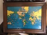 Large wall 'clock' by Howard Miller. Shows the time all over the world. Also lights up