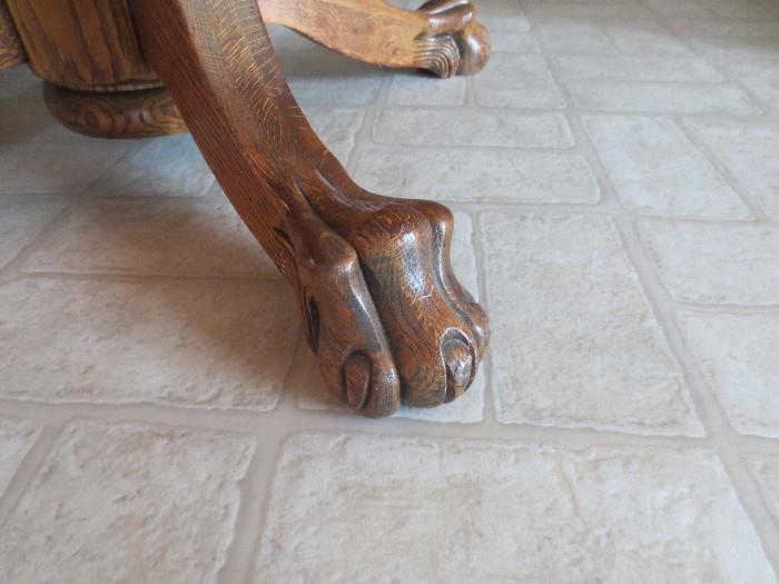 Detailed paw foot on tiger oak table